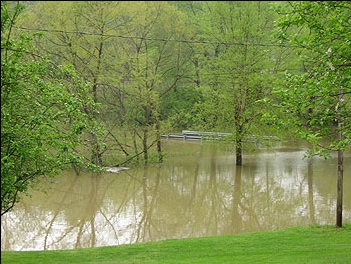 Flooded valley road leading to Camp Wildcat, Kentucky, Civil War Battlefield. Guardrails, now consumed by water, mark the road.