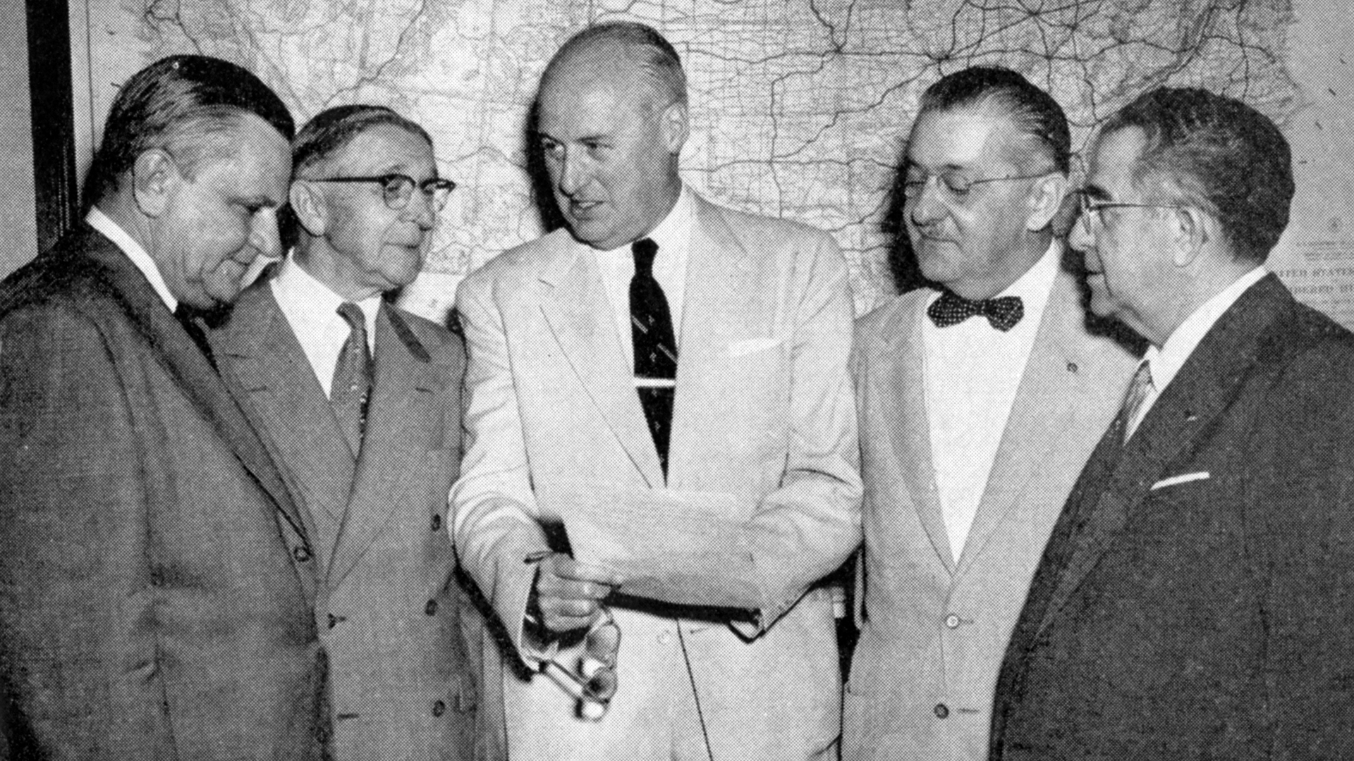 On May 25, 1955, the American Road Builders’ Association (ARBA) testified before the House Subcommittee on Roads on President Eisenhower’s highway proposals. Chairman Fallon met with ARBA’s representatives outside the hearing to discuss their recommendations. (Left to right: Representative Clifford Davis (TN); Representative George A. Dondero (MI); Chairman Fallon; ARBA president John N. Robertson; and Representative J. Harry McGregor (OH).) Left to right: Representative Clifford Davis (TN); Representative George A. Dondero (MI); Chairman Fallon; ARBA president John N. Robertson; and Representative J. Harry McGregor (OH).)