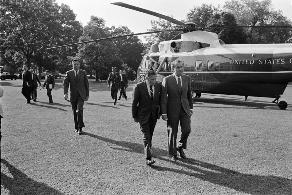 President Richard M. Nixon (in foreground) and Secretary of Transportation John A. Volpe discussed their morning view by helicopter of Washington area traffic. In the group of three men on the left, Federal Highway Administrator Francis C. “Frank” Turner is the trailing figure. Near the helicopter steps, the man behind the officer is John D. Ehrlichman, counsel to the President. (Photo: Richard Nixon Presidential Library and Museum).