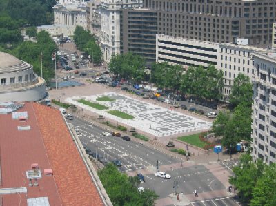 This photo, taken from the Bell Tower at the Old Post Office Building, shows Freedom Plaza along Pennsylvania Avenue. The United States Treasury is seen at the top of the photo. On the left, the circular structure sits atop the Ronald Reagan Building and International Trade Center.