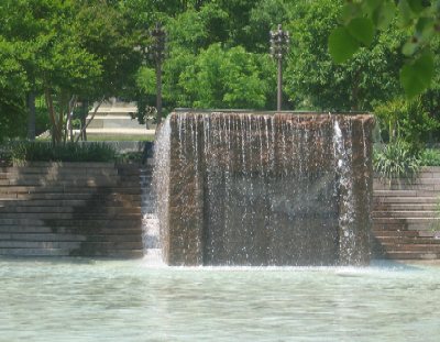 At Pershing Park, this pool and waterfall attract visitors to relax.