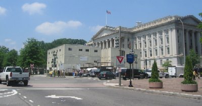 Pennsylvania Avenue disappears at 15th Street for a detour around the Department of the Treasury Building. With renovation of the building underway, the grounds in the rear of the building are taken up by a construction staging area, seen here.