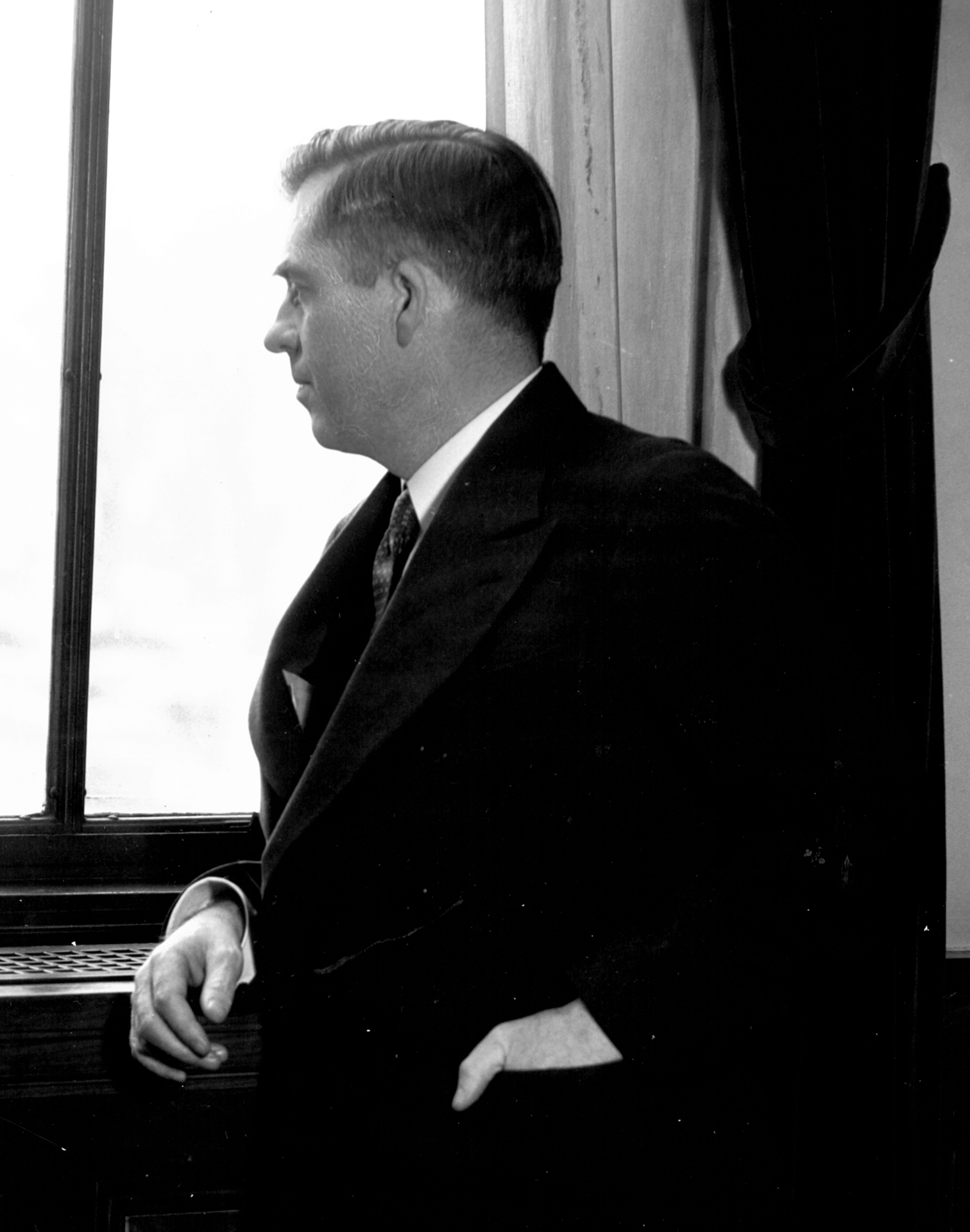 Secretary of Agriculture Henry A. Wallace looking out a window.