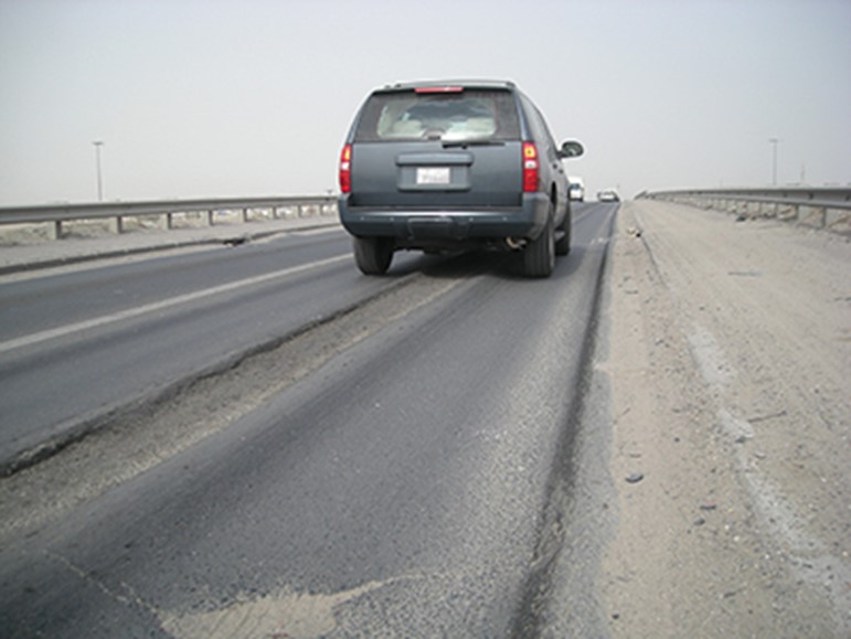 Back of gray vehicle driving on highway