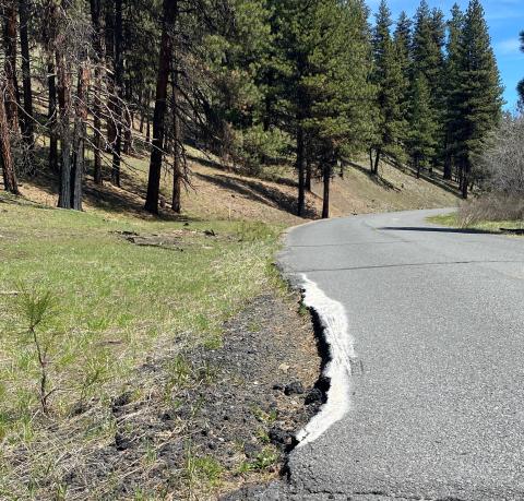 Road narrowing due to edge cracking and erosion in need of repair